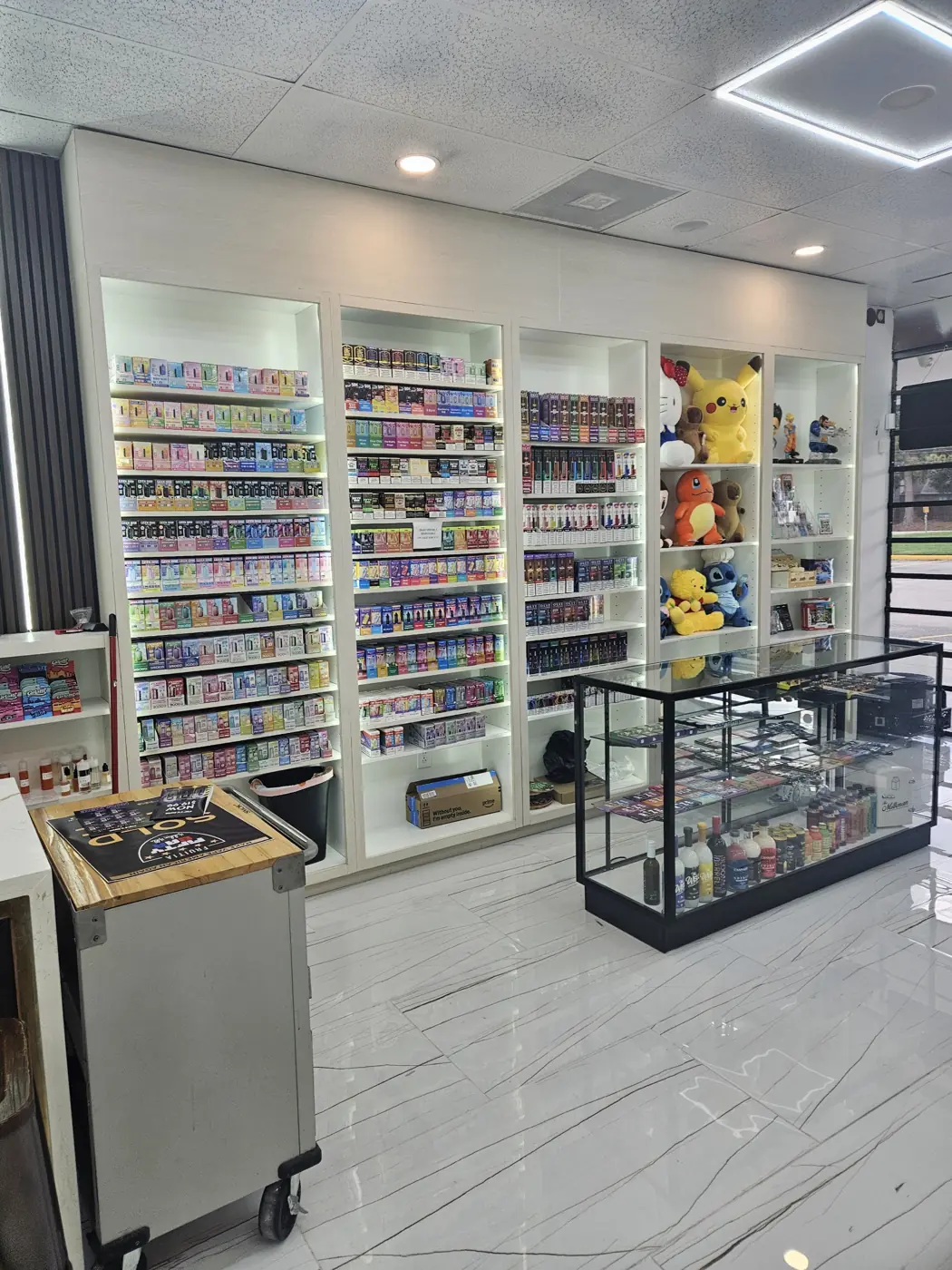 Vape shelves and glass cases inside Huff N Puff Outlaw Vapes on Atascocita Rd